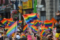LGBT+ Pride Flags waving in a crowd